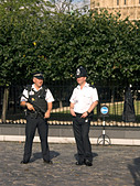 Armed Police officers guard the Houses of Parliament, London, England